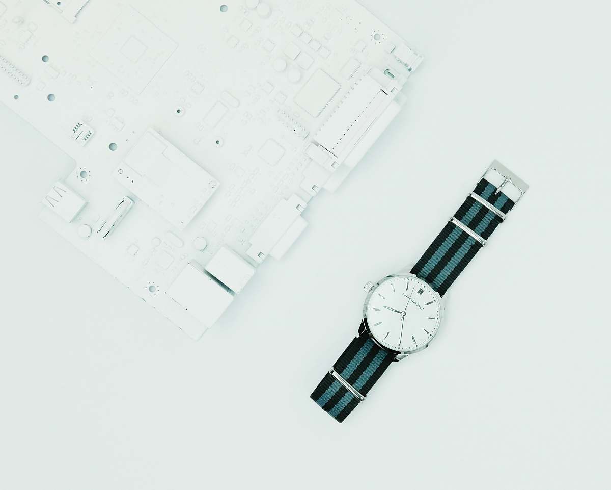 united kingdom round silver-colored analog watch with black band connector